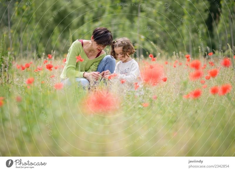 Happy mother with her little daughter in poppy field Lifestyle Joy Beautiful Playing Child Human being Girl Young woman Youth (Young adults) Woman Adults Mother
