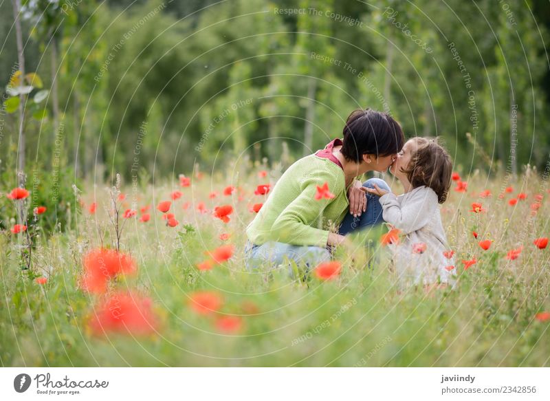 Happy mother kissing her little daughter in poppy field Child Human being Girl Woman Adults Mother Family & Relations Infancy 2 3 - 8 years 30 - 45 years Nature