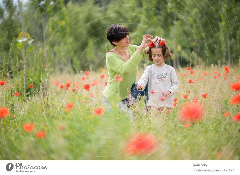 Happy mother with her little daughter in poppy field Lifestyle Joy Playing Child Human being Girl Woman Adults Mother Family & Relations Infancy 2 3 - 8 years