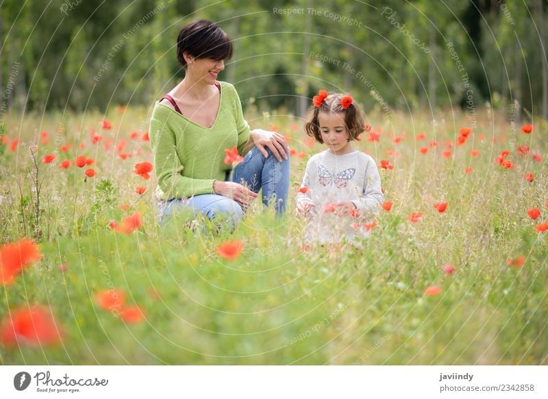 Happy mother with her little daughter in poppy field Lifestyle Joy Child Human being Girl Young woman Youth (Young adults) Woman Adults Mother