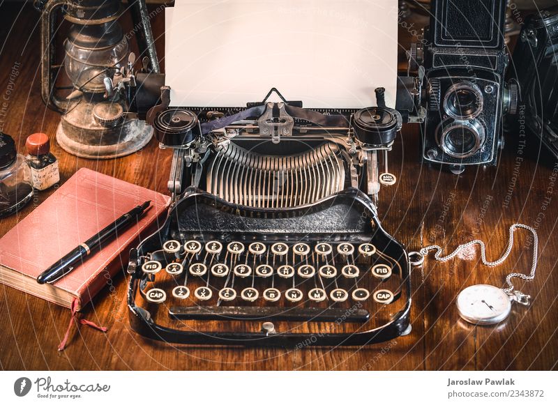 Traditional and old way of writing messages and taking photos, typewriter, camera, watch, pen, Vintage lamp on the desk White ancient antique background black