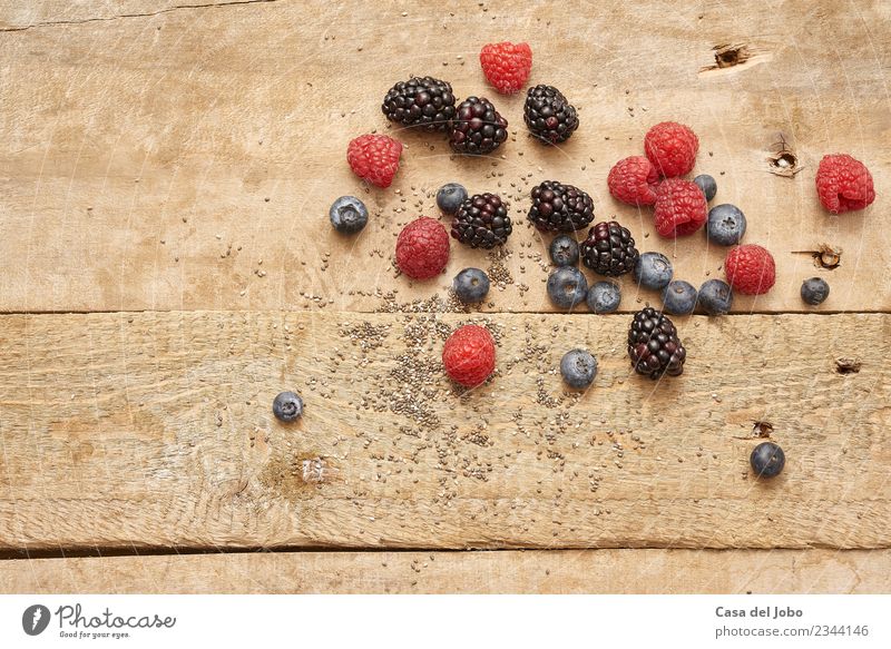 different fresh berries on rustic wooden background Food Fruit Nutrition Organic produce Vegetarian diet Diet Lifestyle Healthy Eating Authentic Good Delicious