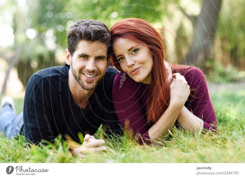 Beautiful young couple laying on grass in an urban park Lifestyle Joy Happy Summer Human being Young woman Youth (Young adults) Young man Woman Adults Man