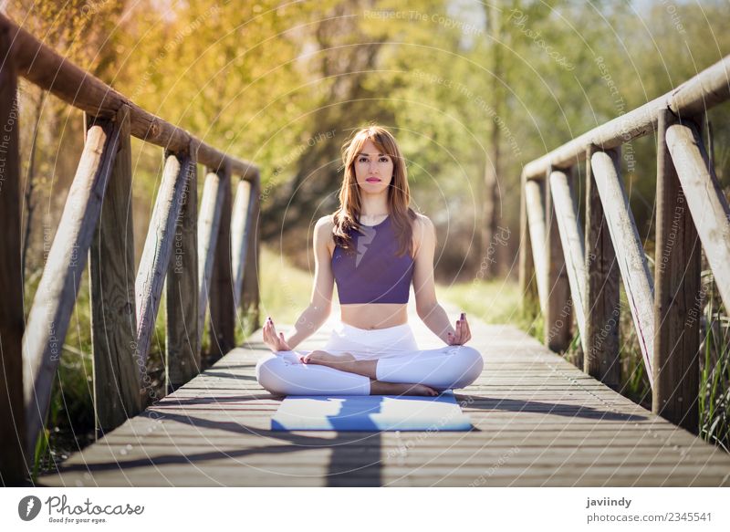 Young woman doing yoga in nature - a Royalty Free Stock Photo from