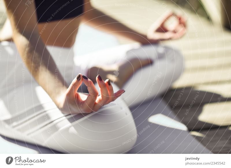 Young woman doing yoga in nature. Lotus figure. - a Royalty Free Stock  Photo from Photocase