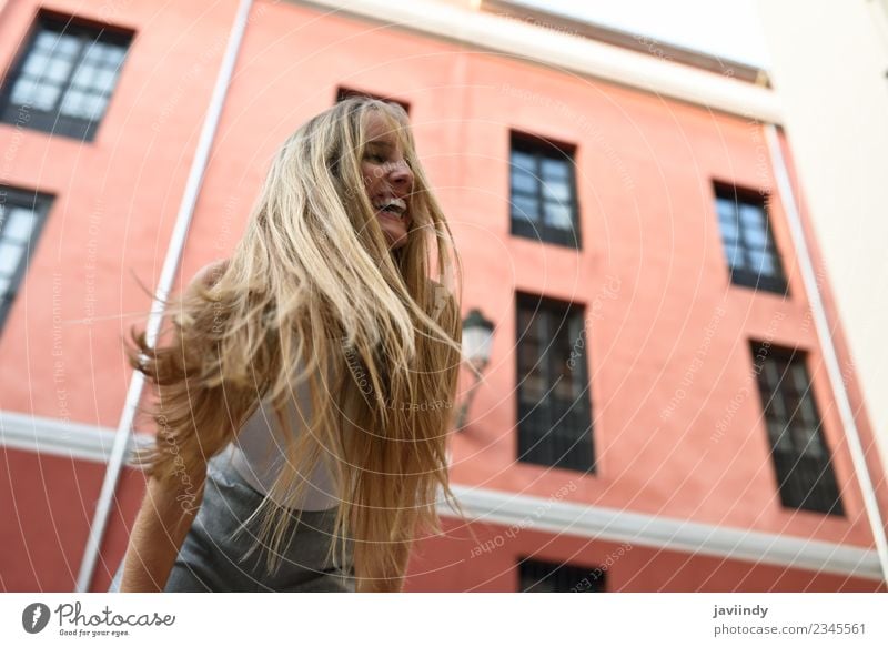 Happy young woman with moving hair in urban background Beautiful Hair and hairstyles Summer Human being Feminine Young woman Youth (Young adults) Woman Adults 1