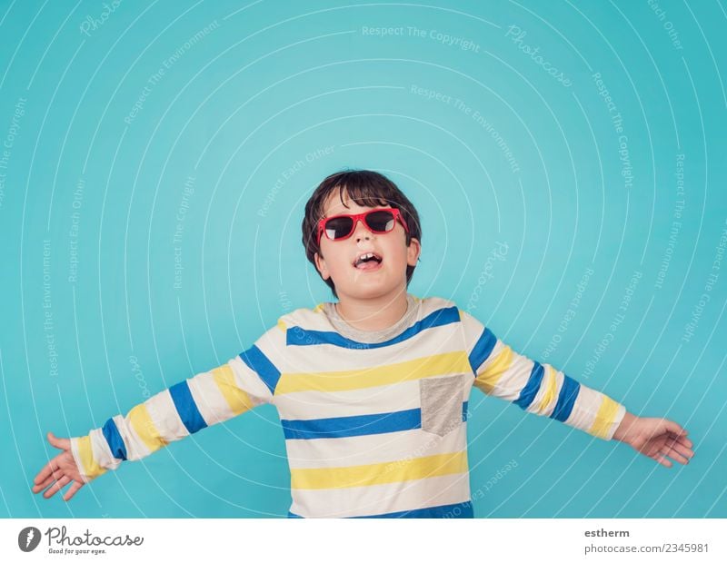 happy boy with sunglasses on blue background Human being Masculine Child Boy (child) Infancy 1 8 - 13 years Sunglasses Movement Fitness Smiling Friendliness