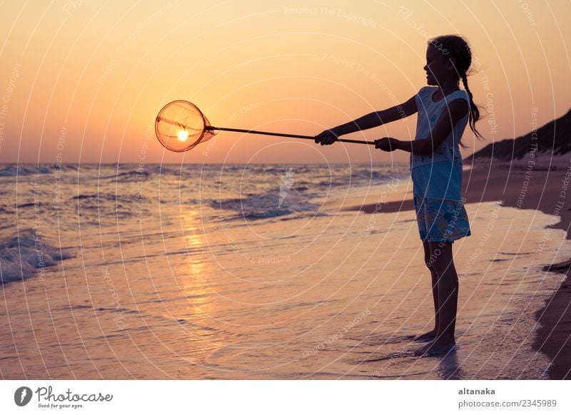 One happy little girl playing on the beach at the sunset time. Lifestyle Joy Happy Beautiful Relaxation Leisure and hobbies Playing Vacation & Travel Trip