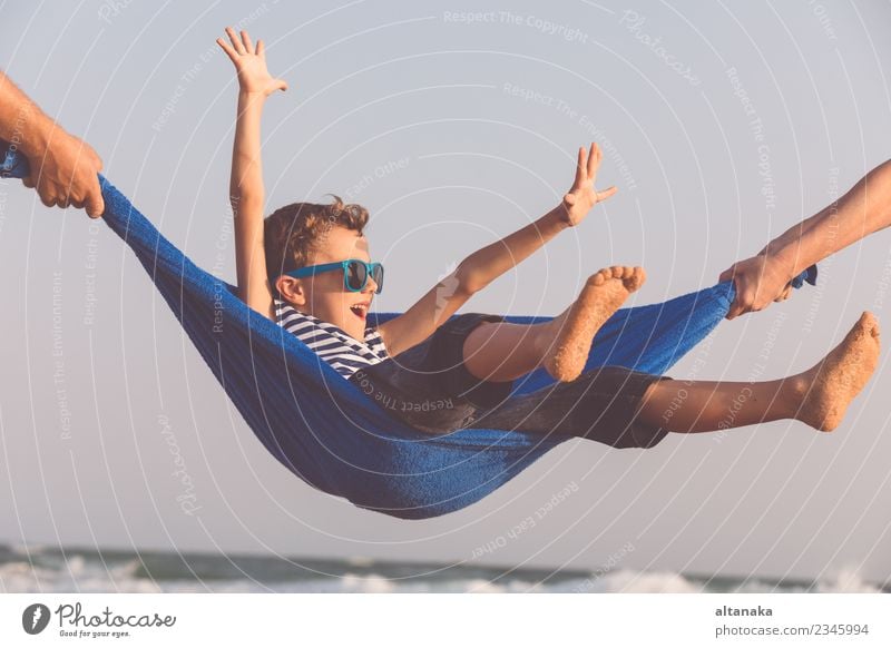 Happy little boy relaxing on the beach at the day time. Lifestyle Joy Relaxation Leisure and hobbies Playing Vacation & Travel Trip Adventure Freedom Summer Sun