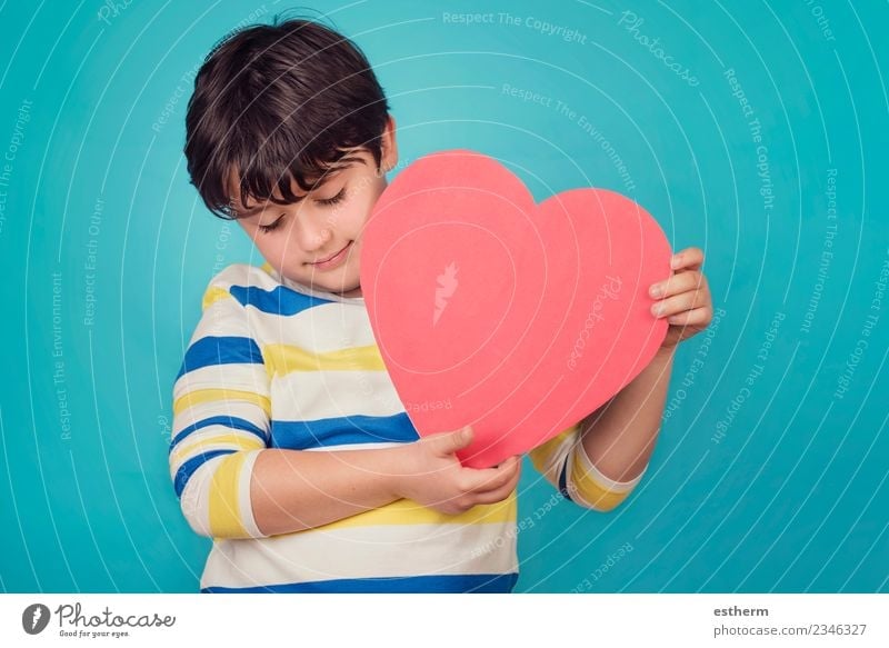 smiling boy with a heart on blue background Lifestyle Joy Party Event Feasts & Celebrations Valentine's Day Mother's Day Human being Child Toddler Boy (child)