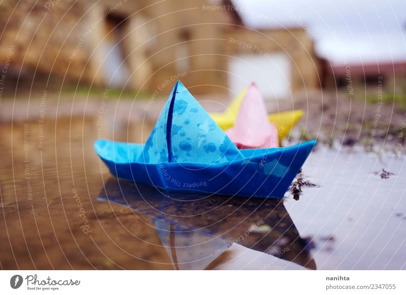 Color paper boats in a puddle in a rainy day Leisure and hobbies Playing Children's game Vacation & Travel Nature Earth Water Drops of water Climate Weather