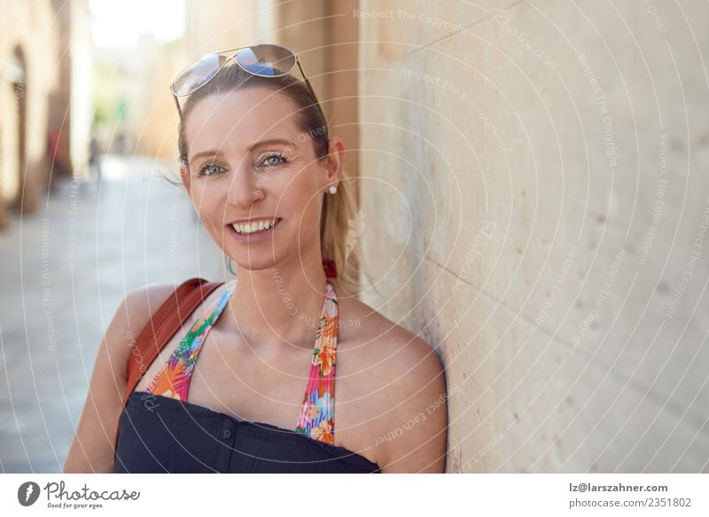 Attractive stylish woman relaxing against a wall Style Happy Face Relaxation Vacation & Travel Tourism Summer Woman Adults 1 Human being 45 - 60 years Warmth