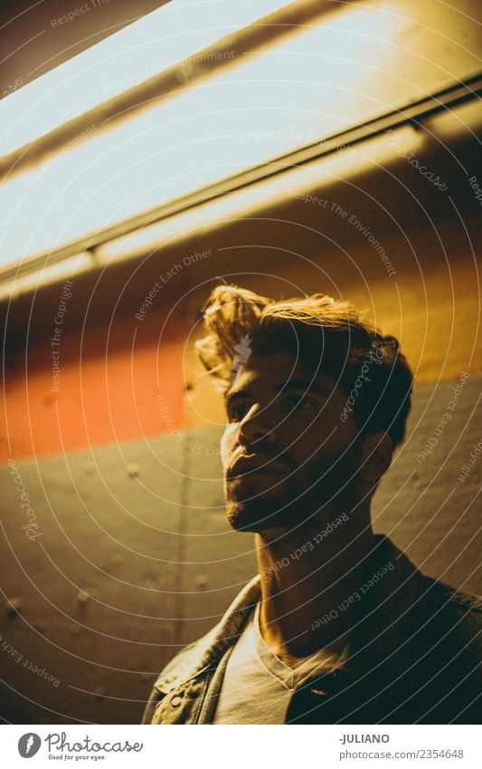 Young modern man is standing under a neon street light at night Dark Fashion Night Night shot Light Parking garage Parking lot City Dark side Hair Hipster