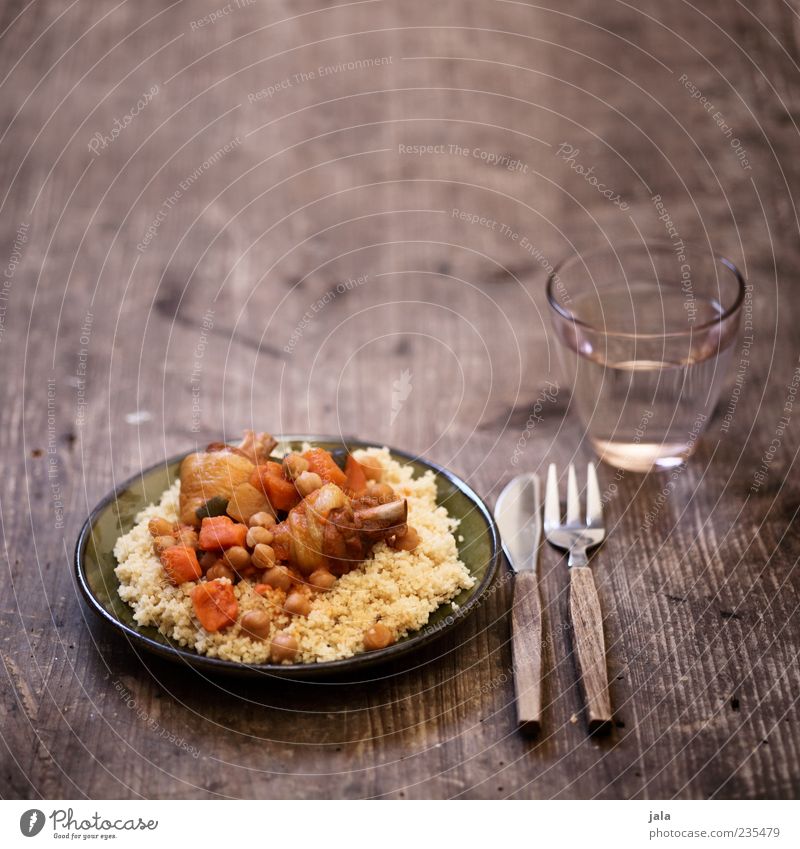 couscous royal Food Meat Vegetable Poultry Nutrition Lunch Beverage Drinking water Crockery Plate Glass Cutlery Knives Fork Delicious Appetite Wooden table