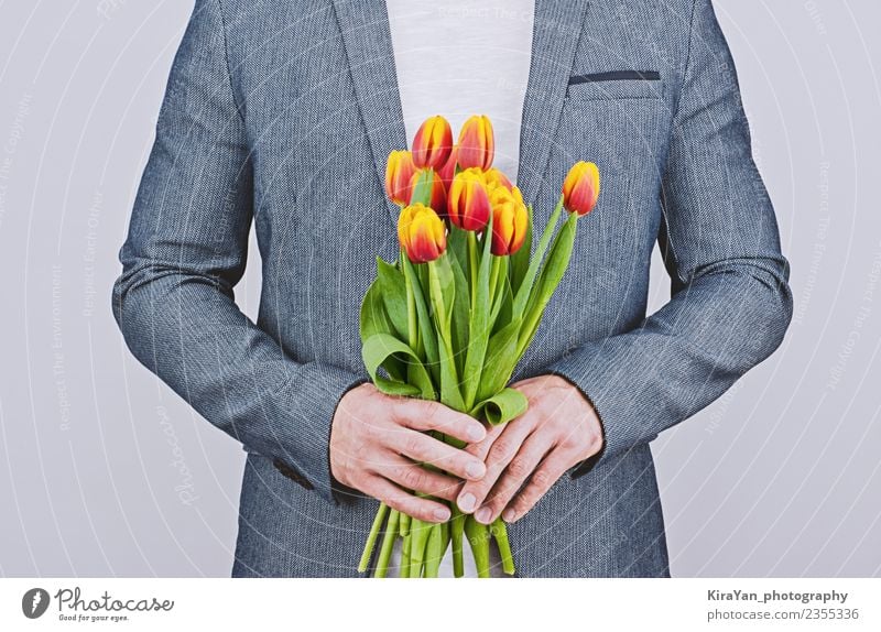 Man in blue jacket holding bouquet of tulips Happy Beautiful Flirt Feasts & Celebrations Valentine's Day Human being Adults Mother Flower Tulip Beard Bouquet