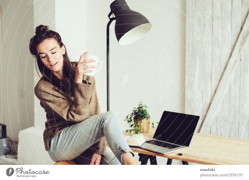 young beautiful woman at home Coffee Lifestyle Joy Relaxation Telephone Computer Notebook Technology Internet Woman Adults Sit Modern Home freelance Cozy