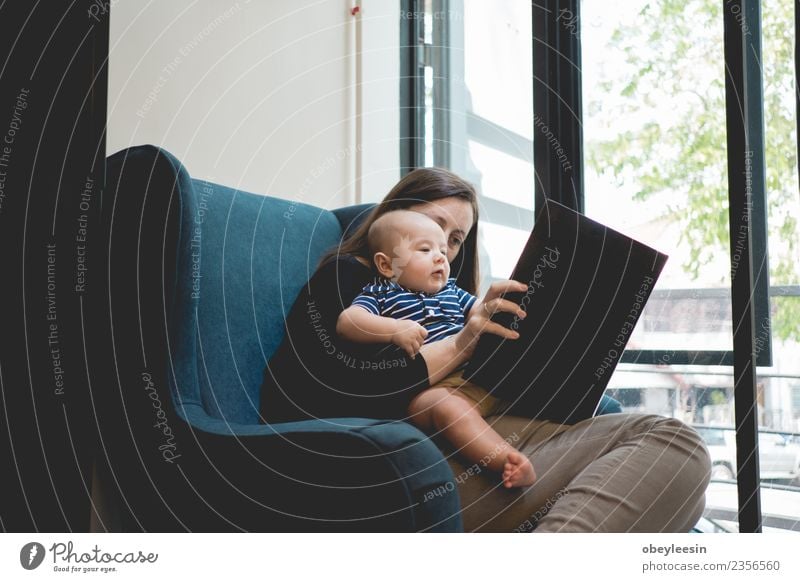 Mother reading a book to her baby son Joy Happy Beautiful Relaxation Leisure and hobbies Playing Reading Child School Human being Baby Toddler Woman Adults