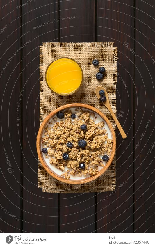 Breakfast Cereal with Blueberries and Milk Fruit Juice Dark Natural food oatmeal Blueberry dry sweet sweetened healthy Meal Snack milk glass Rustic fiber Dairy