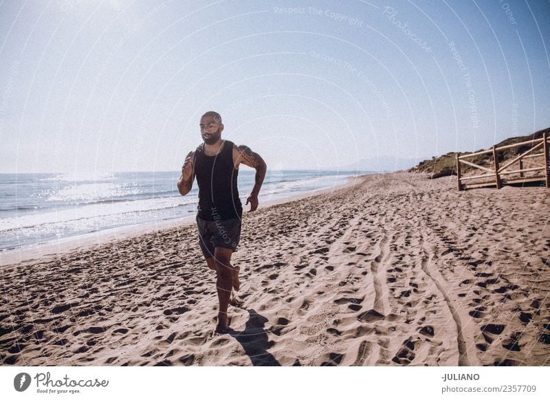 Young sports man is doing running workout at the beach Young man Sports Beach Fitness Sports Training Hard Perspire Musculature Joy Sportsperson Speed Positive