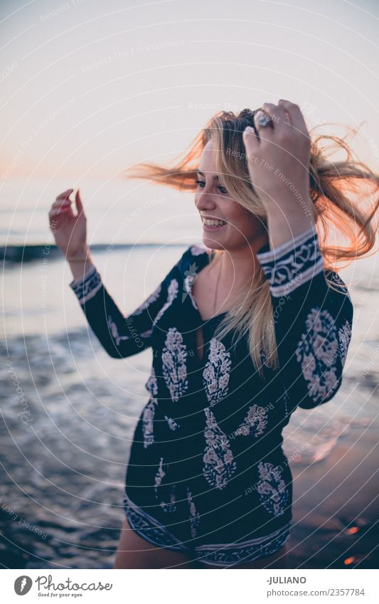 Young woman at the beach while the sunset smiling Sun Beach Blonde Cool (slang) Dusk Joy Girl Good Goodness Laughter Lifestyle Ocean Retro Sand Smiling Summer