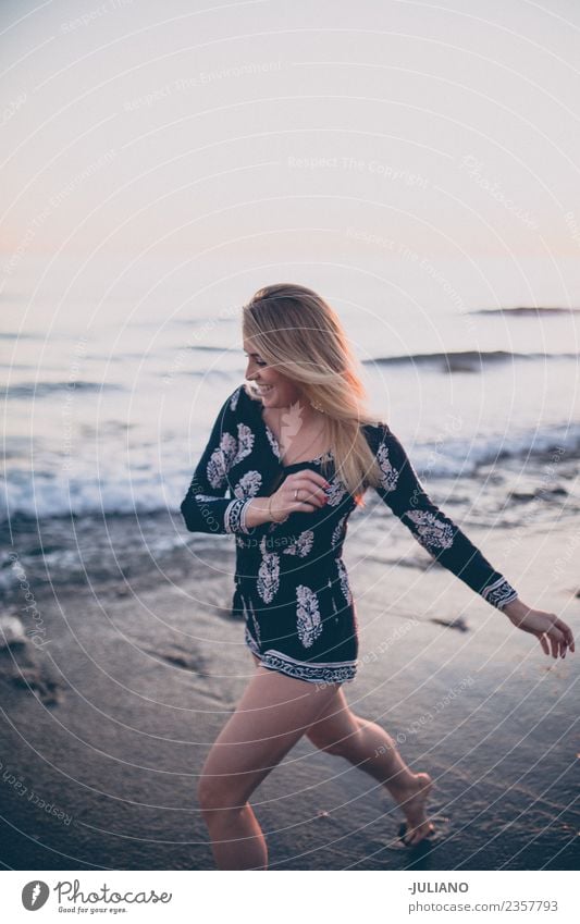 Young woman at the beach running at the ocean laughing Sun Beach Blonde Cool (slang) Dusk Joy Good Goodness Laughter Lifestyle Ocean Retro Sand Smiling Summer