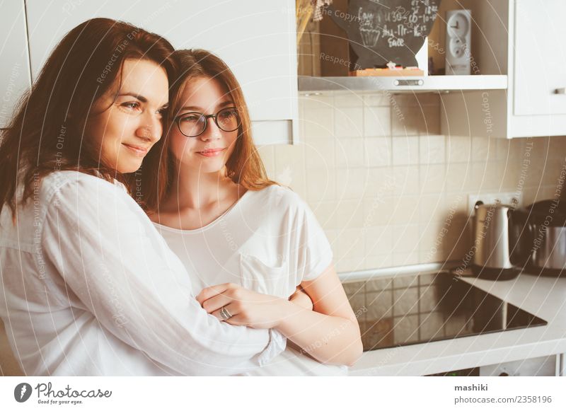mother having breakfast with teen daughter Breakfast Lifestyle Joy Kitchen Child Mother Adults Sister Family & Relations Youth (Young adults) Smiling Embrace