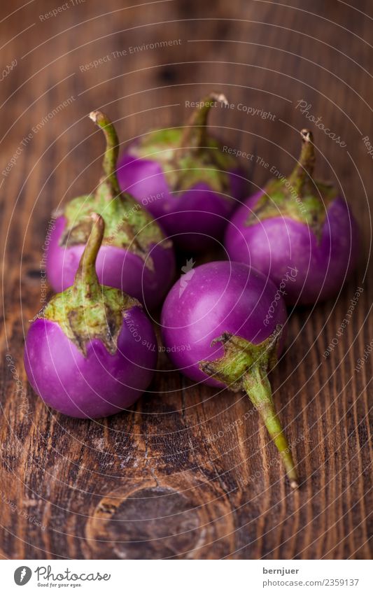 Asian aubergines on dark wood Food Vegetable Nutrition Organic produce Vegetarian diet Diet Asian Food Nature Plant Wood Dark Fresh Small Brown Green Violet