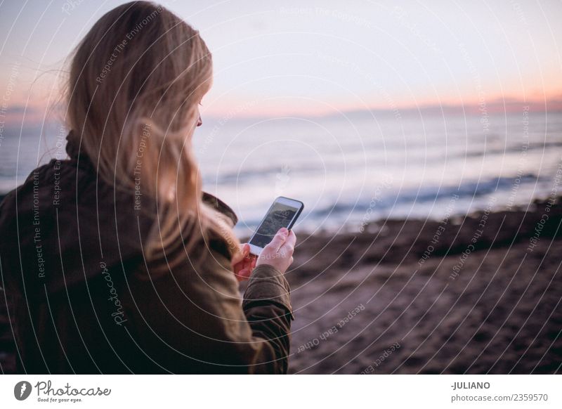 Young woman at the beach using her smartphone Beach Dusk Emotions Happy Life Lifestyle Spain Summer Sun Sunset Warmth Adventure Communication Freedom Joy Good