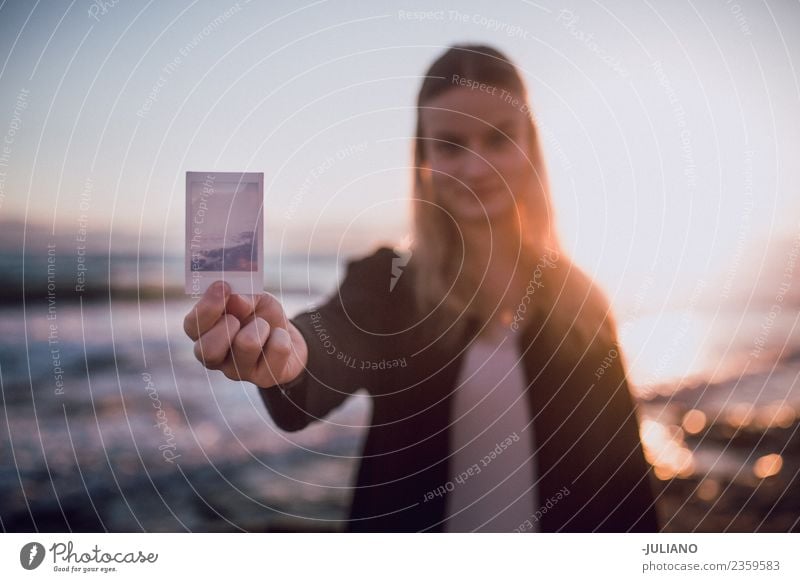 Young woman holding polaroid picture at the beach Beach Dusk Emotions Girl Happy Life Lifestyle Spain Summer Sun Sunset Warmth Adventure Communicate Freedom Joy