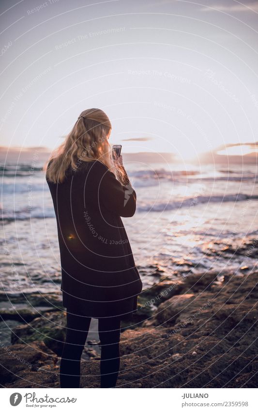 Young woman is taking picture of sunset at the beach Beach Dusk Emotions Happy Life Lifestyle Spain Summer Sun Sunset Warmth Adventure Communicate Communication