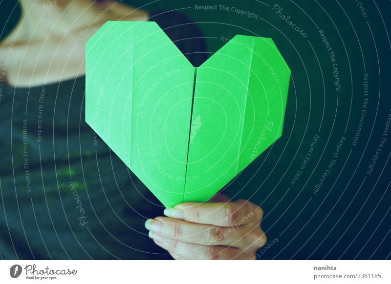 Young woman holding a green paper heart Style Design Leisure and hobbies Handcrafts Origami Paper Human being Feminine Youth (Young adults) Woman Adults 1