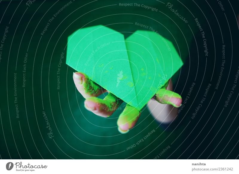 Hand holding a green paper heart Design Exotic Handcrafts Origami Paper Art Artist Painted Paints and varnish Powder paint Sign Heart Dirty Dark Authentic