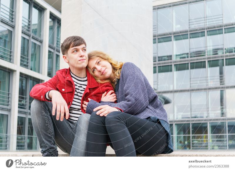 young couple sitting on the stairs in front of a modern building Lifestyle Human being Young woman Youth (Young adults) Young man Woman Adults Man Friendship