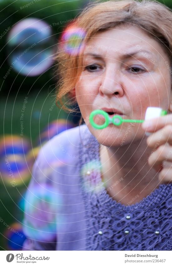 Fun for the whole family Woman Adults Head Face 1 Human being 45 - 60 years Summer Soap bubble Blow Dream Sphere Effortless Colour photo Exterior shot Day Light