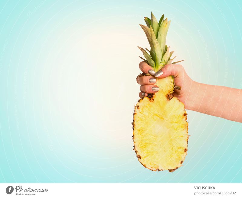 Hand with half of the pineapple on blue background Food Fruit Style Design Joy Healthy Eating Vacation & Travel Summer Feminine Pineapple Half Tropical Sky