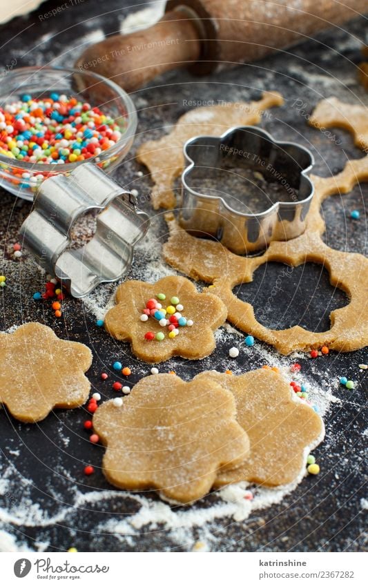 Cooking cookies with flower cookie cutters on a dark table Dough Baked goods Dessert Kitchen Flower Metal Make Brown Tradition Baking Bakery biscuit cooking