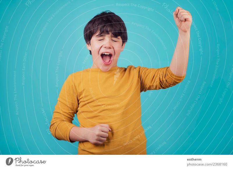 smiling and euphoric boy on blue background Lifestyle Joy Human being Masculine Child Boy (child) Infancy 1 8 - 13 years Feasts & Celebrations Fitness Smiling