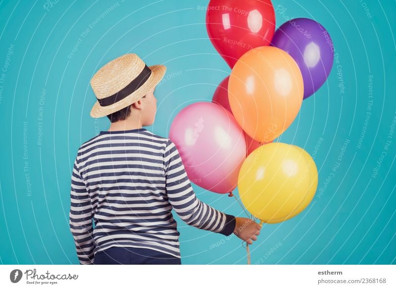 thoughtful boy with balloons on blue background Human being Masculine Child Toddler Infancy 1 8 - 13 years Hat Balloon Think Fitness Dream Sadness Cuddly