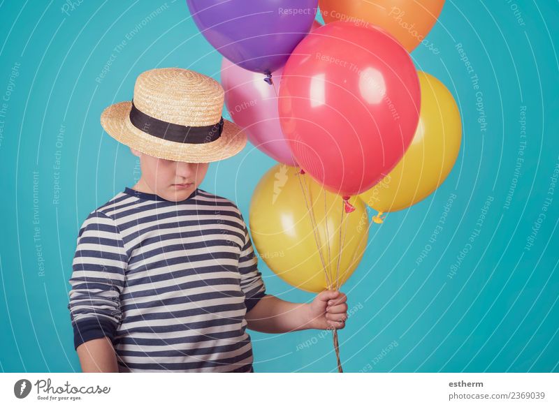 thoughtful boy with balloons on blue backgroun Lifestyle Human being Masculine Child Toddler Infancy 1 8 - 13 years Hat Balloon Think Fitness Cuddly Moody