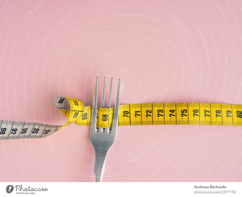 diet Nutrition Diet Fasting Lifestyle Healthy Healthy Eating Overweight Fitness Yellow Pink copy space Tape cassette fork measure loose isolated white concept