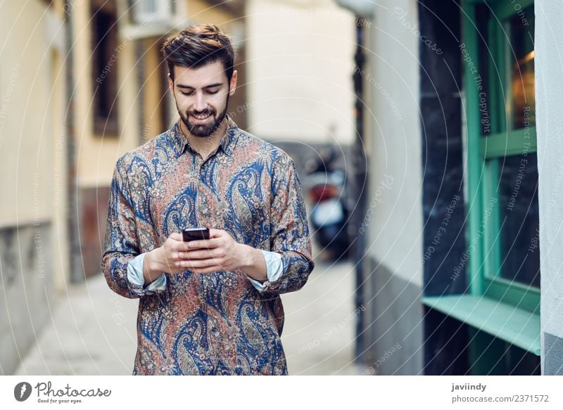 Young smiling man looking at his smart phone outdoors Lifestyle Style Beautiful Hair and hairstyles Telephone PDA Human being Young man Youth (Young adults) Man