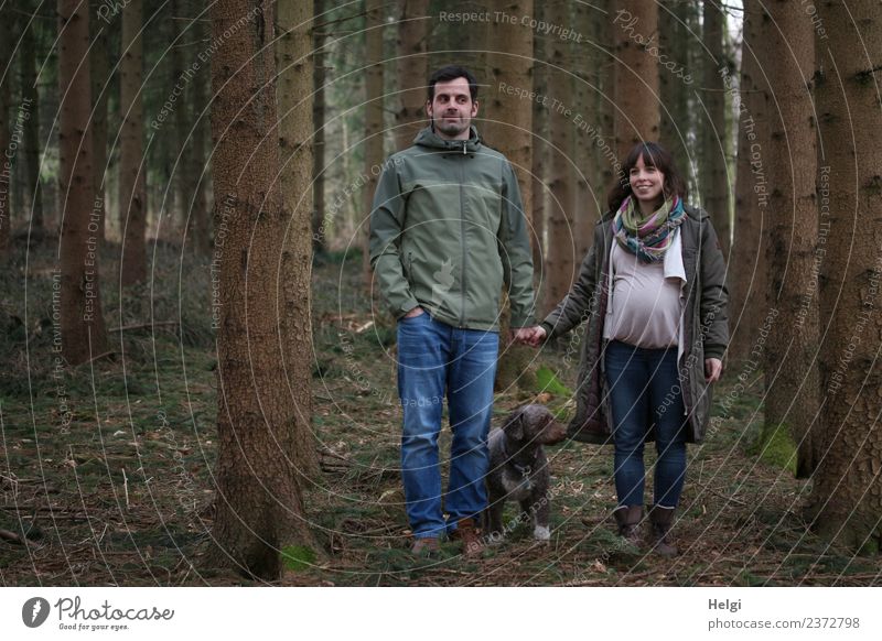 young couple with dog is in the woods, the woman is pregnant Human being Masculine Feminine Woman Adults Man Couple Partner 2 30 - 45 years Environment Nature