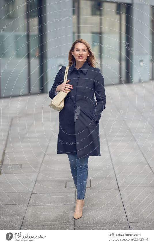 Attractive woman in jeans and an overcoat Style Happy Beautiful Work and employment Office Business Career Woman Adults 1 Human being 45 - 60 years Building