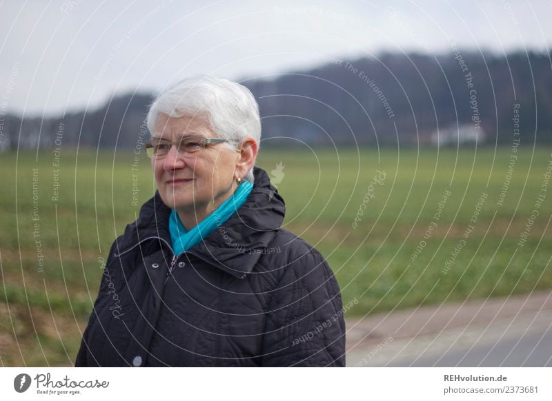 Senior citizen out and about in the countryside Upper body portrait Shallow depth of field blurriness Day Copy Space left 60 years and older Female senior