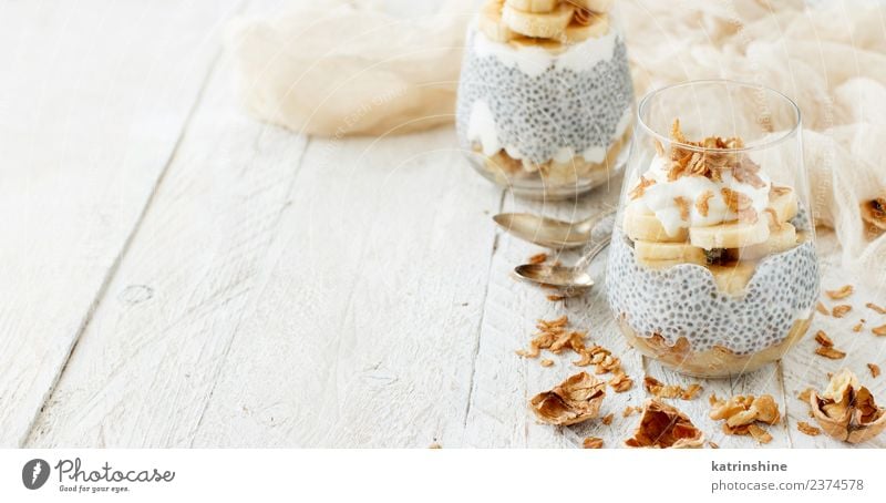 Chia pudding parfait, layered with banana and granola Yoghurt Fruit Dessert Eating Breakfast Diet Bowl Spoon White Cereal chia Pudding seed Dairy glass Gourmet