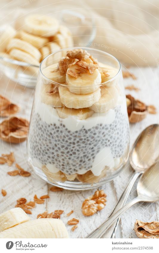Chia pudding parfait, layered with banana and granola Yoghurt Fruit Dessert Eating Breakfast Diet Bowl Spoon White Cereal chia Pudding seed Dairy glass Gourmet