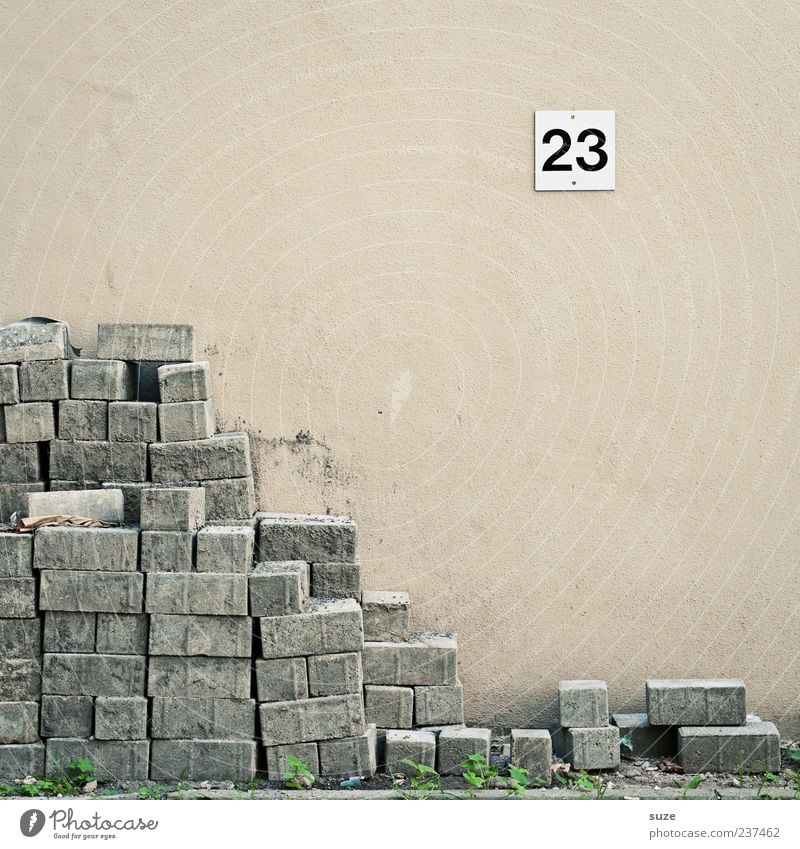 stoning Construction site Career Unemployment Wall (barrier) Wall (building) Stone Digits and numbers Signs and labeling Gloomy Corner 23 Material Stack