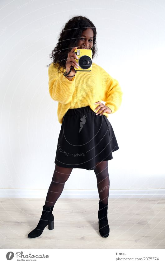 Apolline Room Feminine Woman Adults 1 Human being Skirt Sweater Boots Black-haired Long-haired Curl Camera Observe To hold on Smiling Laughter Looking Stand
