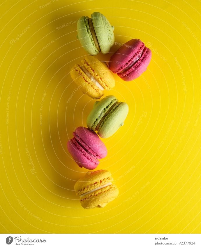 macarons in the middle Dessert Candy Eating Bright Yellow Green Pink Colour Idea Macaron background food colorful Vanilla french cake Vantage point Top sweet