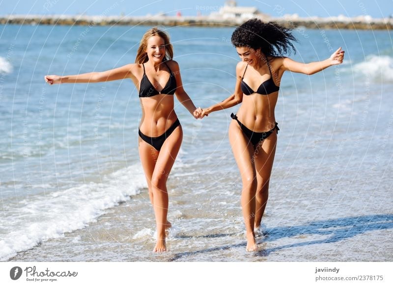 Voordracht altijd Milieuvriendelijk Two young women in bikini having fun on a tropical beach - a Royalty Free  Stock Photo from Photocase